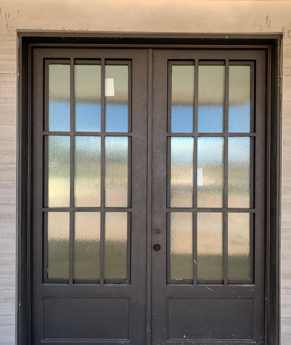 Iron French double doors with nine lites and textured glass