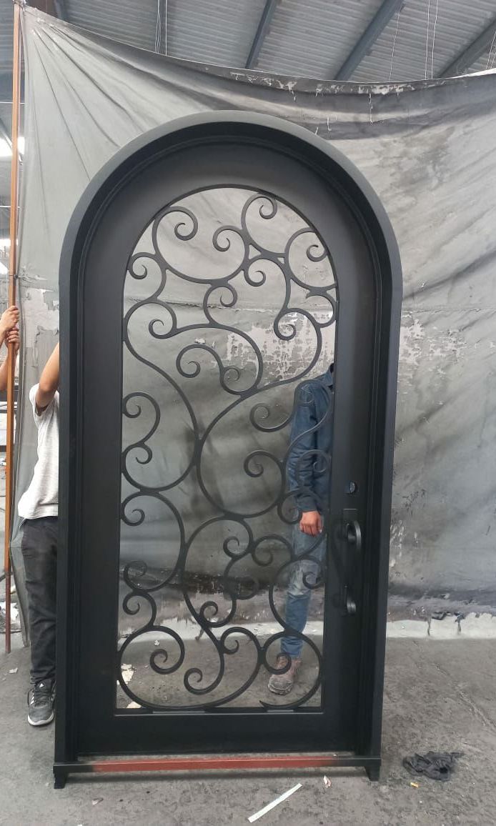 Round-top wrought iron single door with full scroll pattern