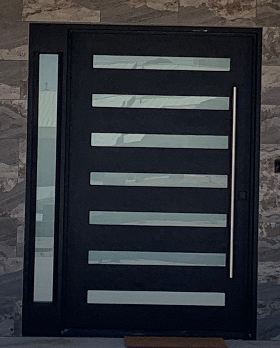 Modern black pivot door with horizontal frosted glass strips and sidelight