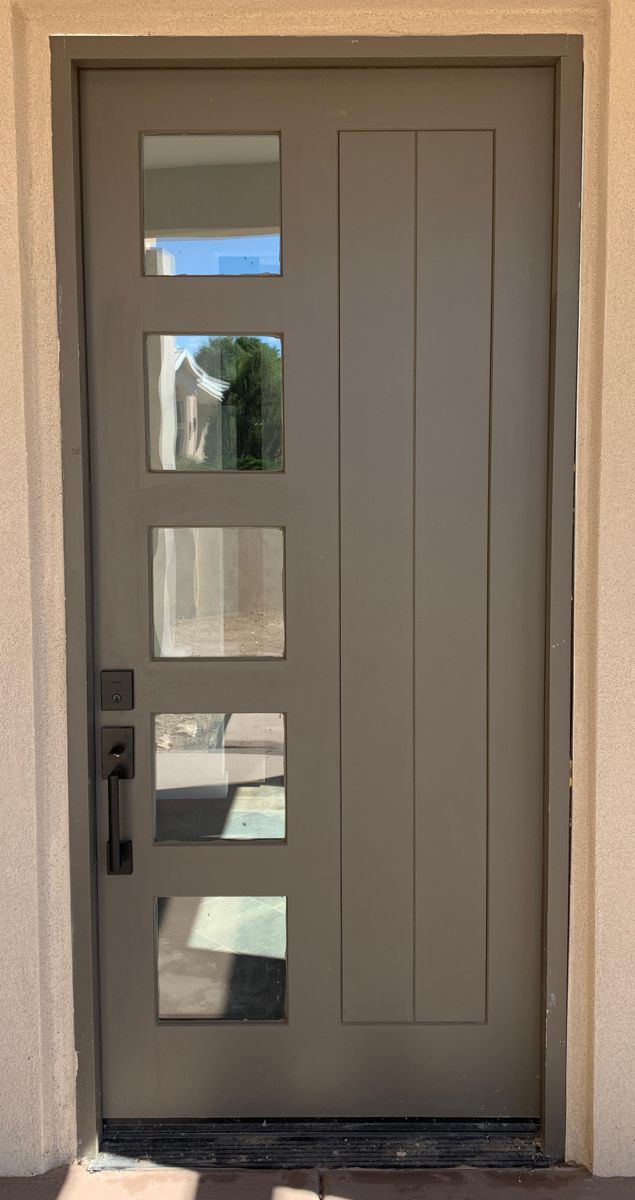 Modern gray entry door with five glass lites and black handle set