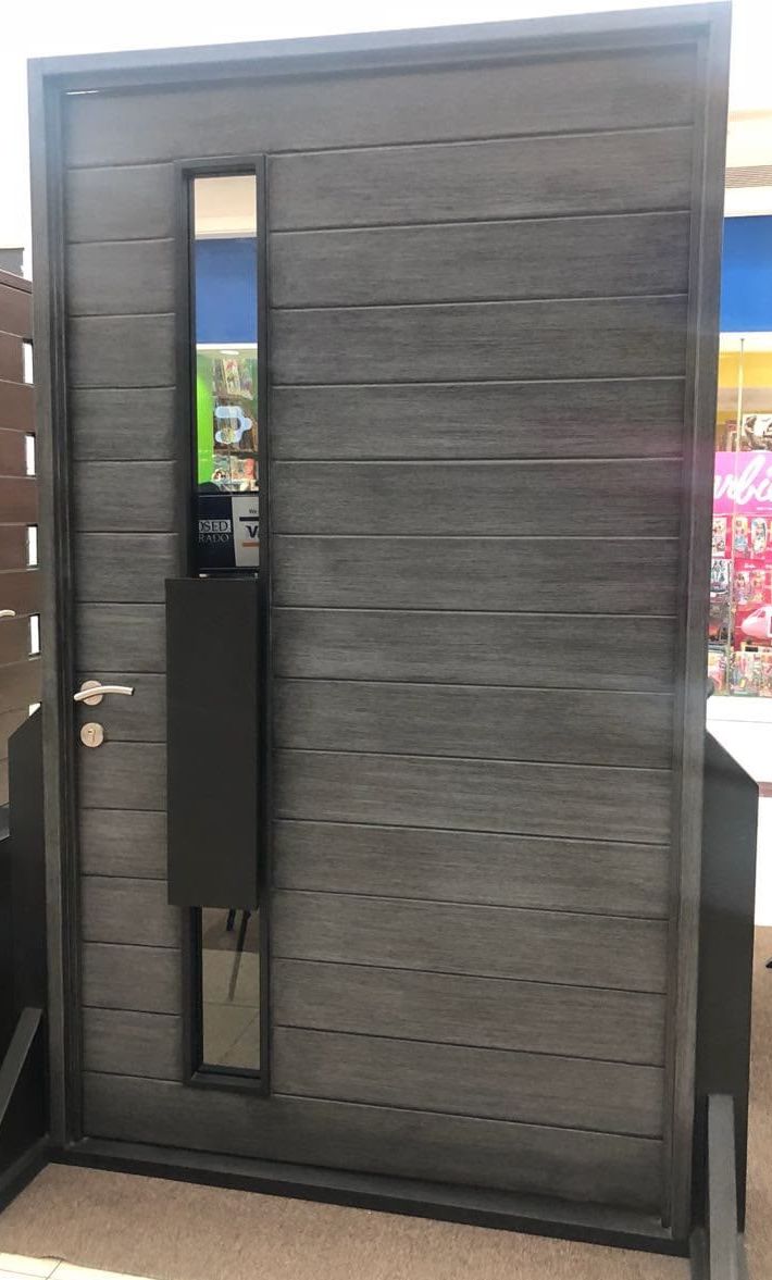 Modern gray entry door with vertical glass slot and black pull plate